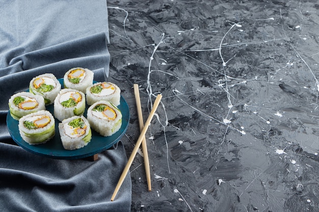 Sushibroodjes, sojasaus, wasabi en ingemaakte gember op steenachtergrond.