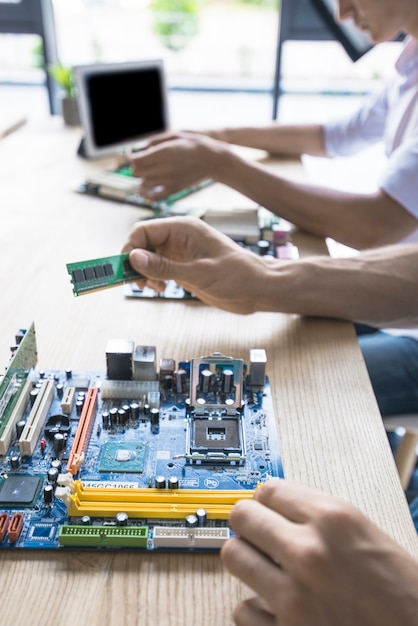Technicus die het computermotherboard herstelt