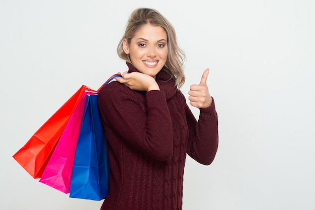 Tevreden jonge vrouwenholding het winkelen zakken