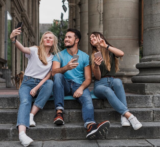 Tieners zitten op trappen en nemen een selfie