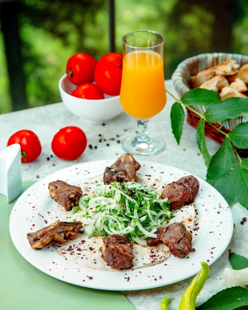 Tikka kebab met flatbread, ui, kruiden en sumak