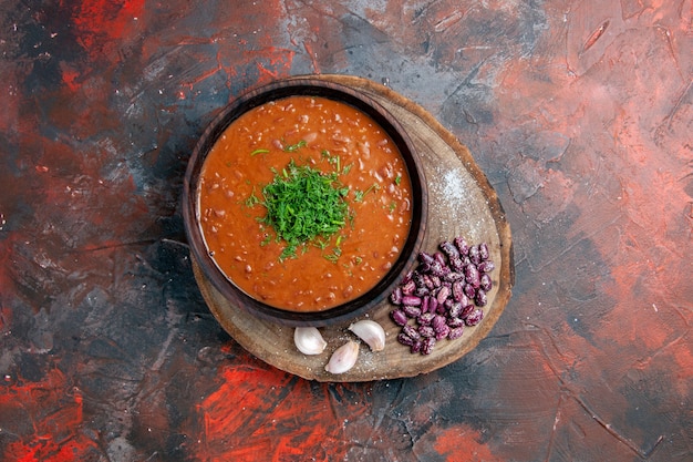 Tomatensoep bonen knoflook op houten snijplank op mix kleurentabel