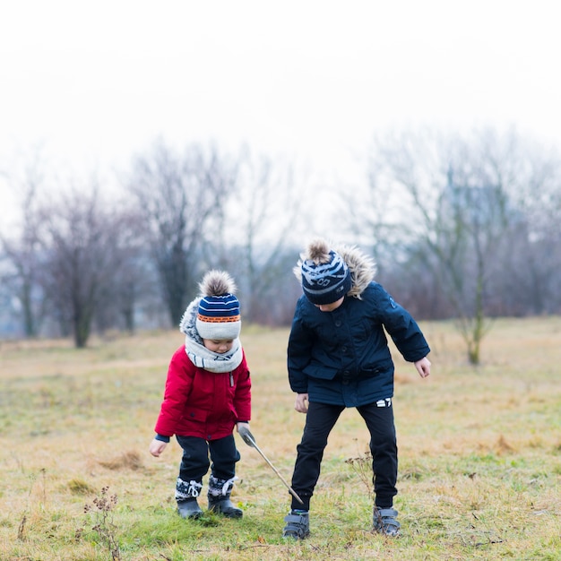 Gratis foto twee kinderen spelen buiten op een regenachtige dag