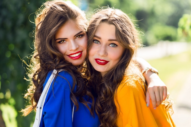 twee mooie vrouwen knuffelen en glimlachen