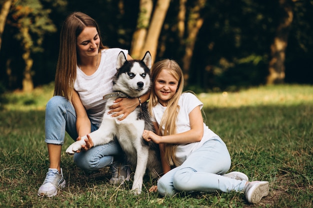 Twee zussen met hun hond in park