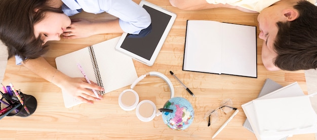 Uitgeputte studenten die aan een bureau slapen