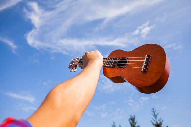 Ukelele gitaar die in de lucht wordt gehouden