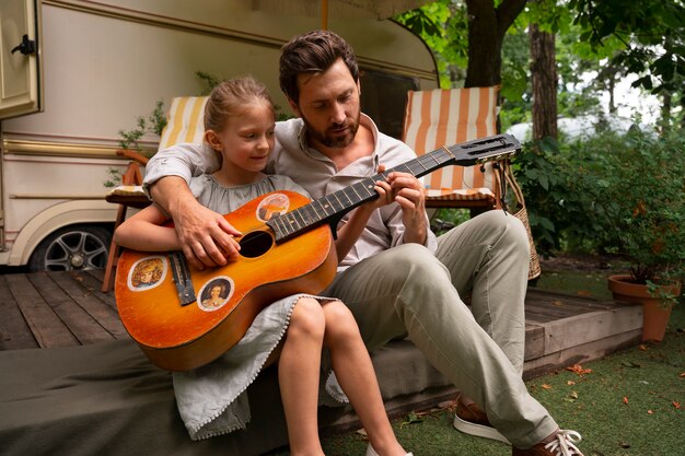 Vader en dochter met gitaar in linnen kleding