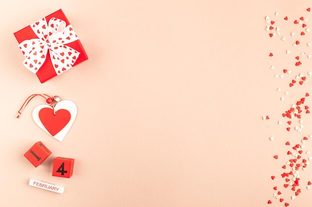 Valentijnsdag samenstelling met geschenkdoos harten en lint op kalmerende koraal achtergrond plat lag kopie ruimte wenskaart mockup voor Valentijnsdag