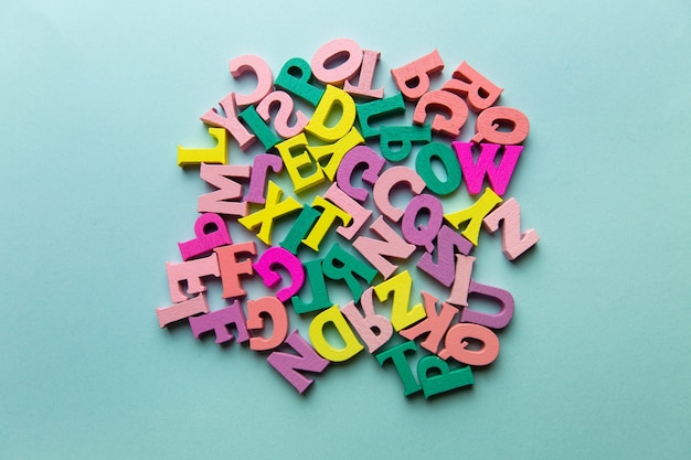 Veelkleurige kleine letters verspreid in een chaotisch close-up plat lag concept van basisschool
