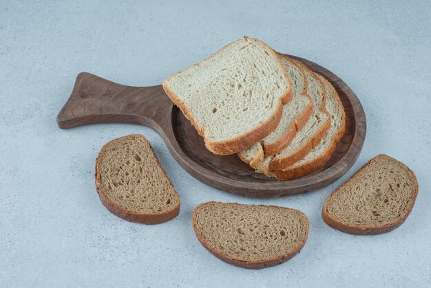 Verscheidenheid van sneetjes brood op een houten bord