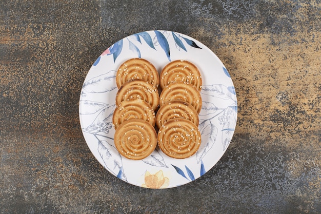 Verschillende smakelijke koekjes op kleurrijke plaat.