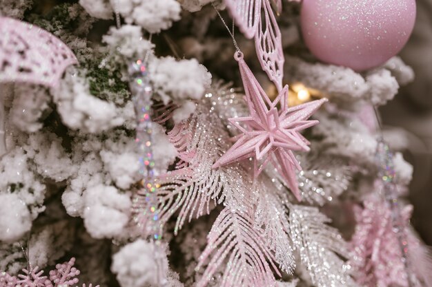 Verschillende speelgoedgeschenken die aan een versierde kerstboom hangen