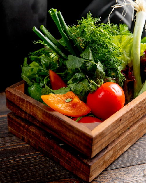 Verse groenten en greens in houten doos