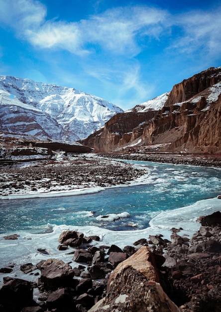 Verticaal schot van Spiti-vallei in de winter met bevroren rivier en sneeuwpiekbergen