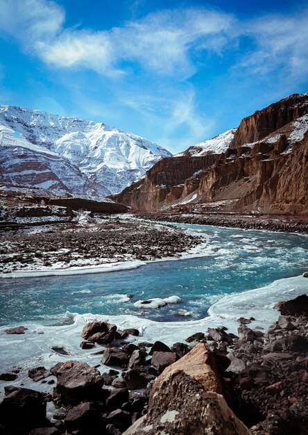 Verticaal schot van Spiti-vallei in de winter met bevroren rivier en sneeuwpiekbergen