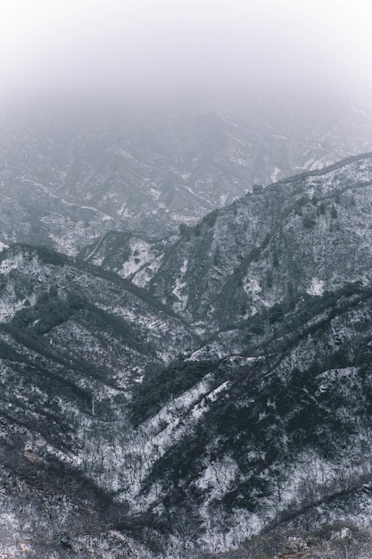 Gratis foto verticale opname van bergen bedekt met witte sneeuw tijdens de winter