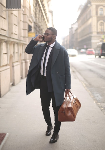 Verticale shot van een goed geklede African American man praten aan de telefoon