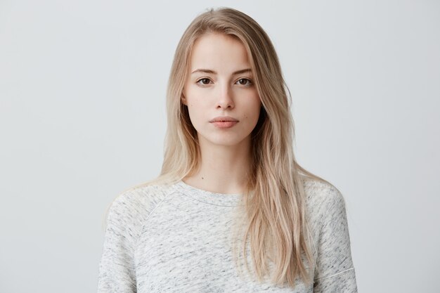 Vertrouwen knappe mooie vrouw met blond geverfd haar gekleed in casual kleding op zoek serieus