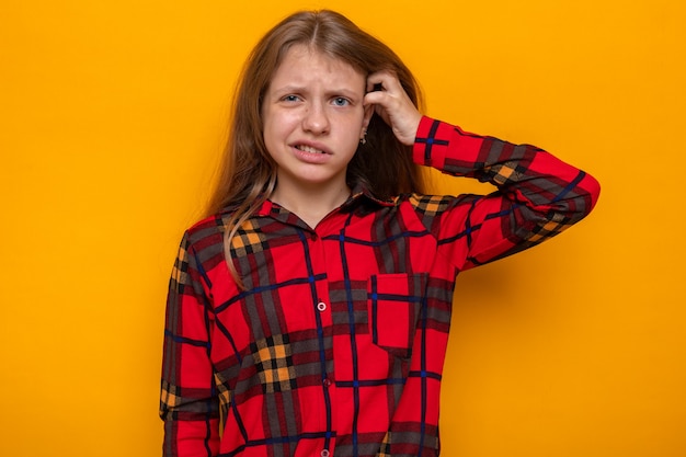 Gratis foto verward krabben hoofd mooi klein meisje dat rood shirt draagt