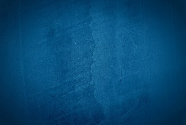 Vintage grunge blauwe concrete textuur studio muur achtergrond met vignet.