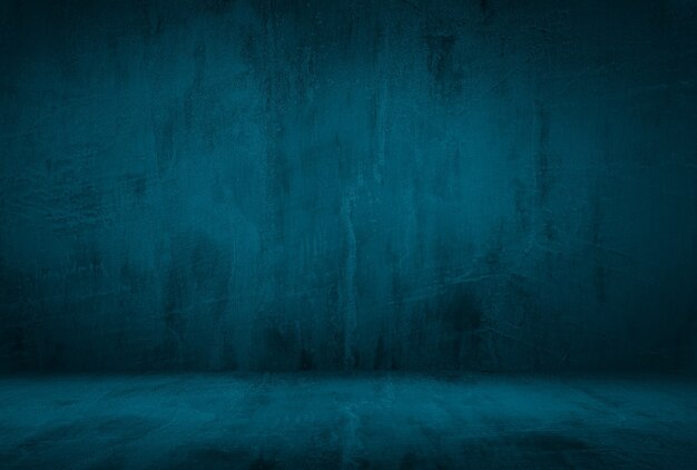 Vintage grunge blauwe concrete textuur studio muur achtergrond met vignet.