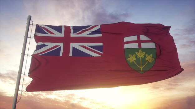 Vlag van ontario, canada, zwaaiend in de wind, lucht en zon achtergrond. 3d-rendering Premium Foto
