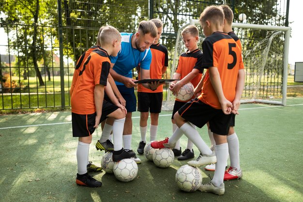 Voetbaltrainer die zijn leerlingen lesgeeft