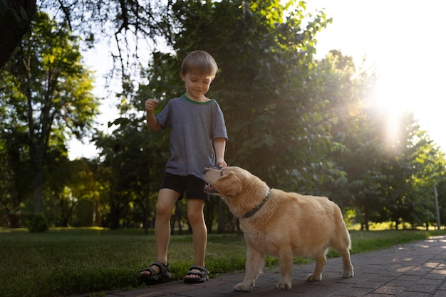 Volledig geschoten jongen en hond in park