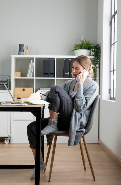 Volledige shot vrouw praten over de telefoon