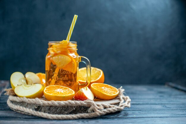 Vooraanzicht cocktail gesneden sinaasappelen en appels op een houten bord op donkere geïsoleerde achtergrond