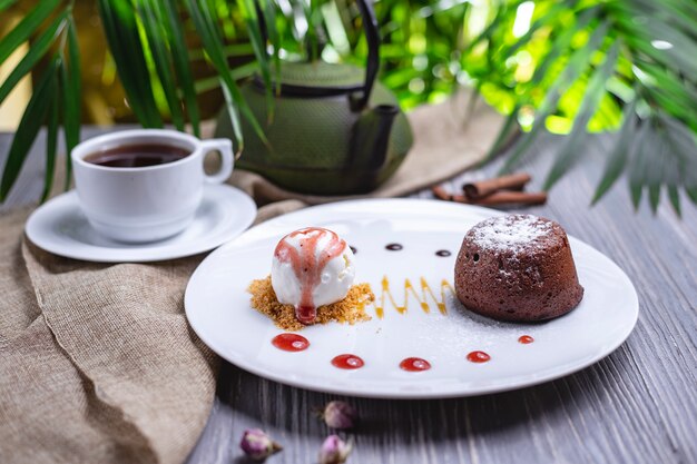 Vooraanzicht dessert chocolade fondant met ijs en een kopje thee