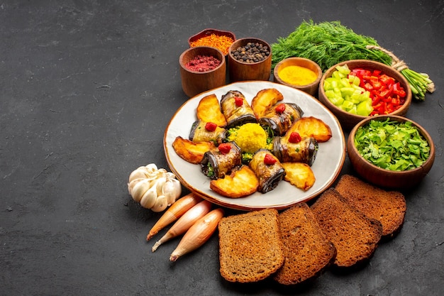 Vooraanzicht heerlijke aubergine rolt gekookte schotel met aardappelen en broden op donkere achtergrond koken voedsel schotel bak bak aardappel