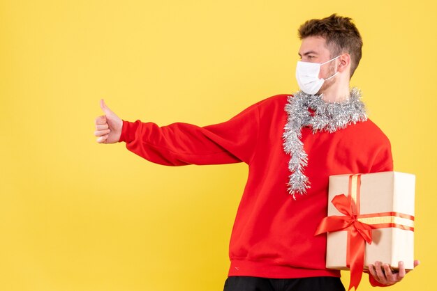 Vooraanzicht jonge mannelijke kerst aanwezig in steriel masker