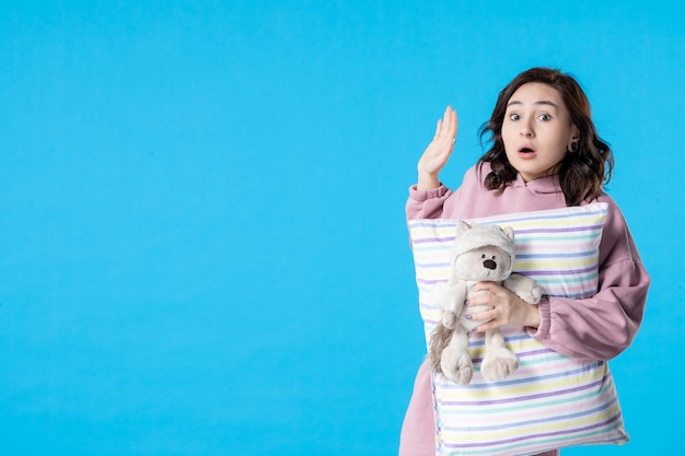 Vooraanzicht jonge vrouw in roze pyjama praten met iemand op blauwe slapeloosheid bed nacht nachtmerrie droom feest rust