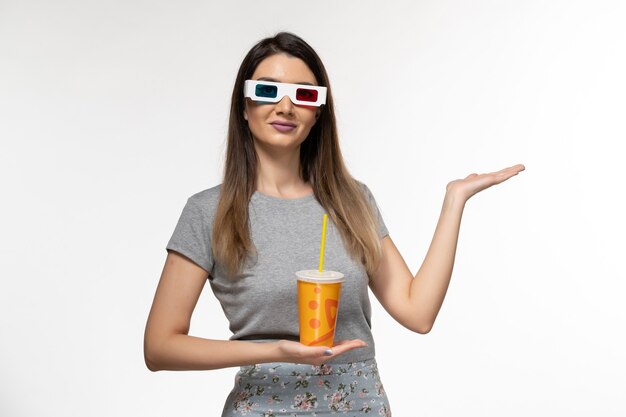 Vooraanzicht jonge vrouwelijke frisdrank drinken in d zonnebril op wit oppervlak