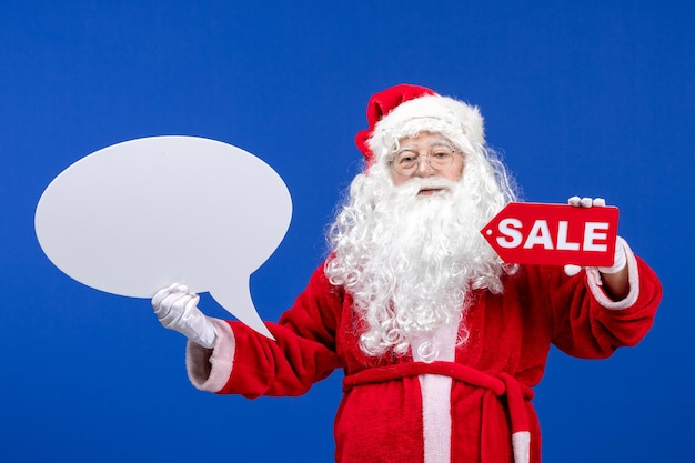 Vooraanzicht kerstman met verkoop en groot wit bord op blauwe kleur sneeuwvakantie nieuwjaar kerstmis