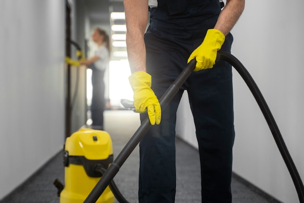 Gratis foto vooraanzicht man binnenshuis schoonmaken