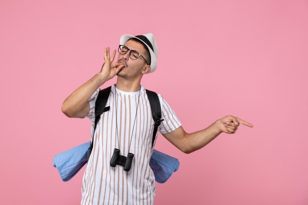 Vooraanzicht mannelijke toerist poseren met rugzak op de roze muur emotie toeristische kleur