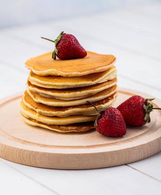 Vooraanzicht pannenkoeken met aardbeien op een dienblad