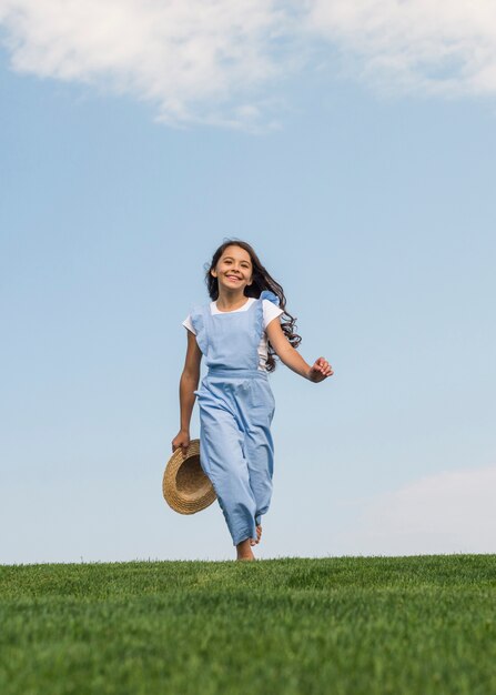 Vooraanzicht schattig meisje lopen op gras