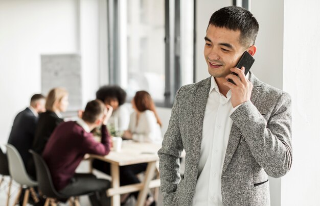 Vooraanzicht van de mens die bij zijn telefoon spreekt