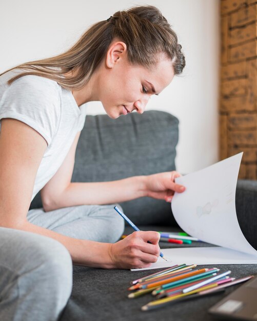 Vooraanzicht van de vrouw die op de bank werkt