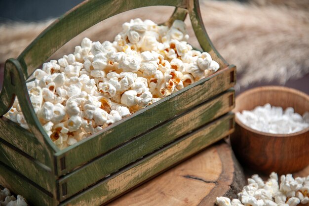 Vooraanzicht van dichtbij verse popcorn op het donkere oppervlak snack popcorn maïsvoedsel