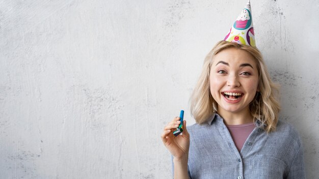 Vooraanzicht van gelukkige vrouw met feestmuts en kopieer de ruimte