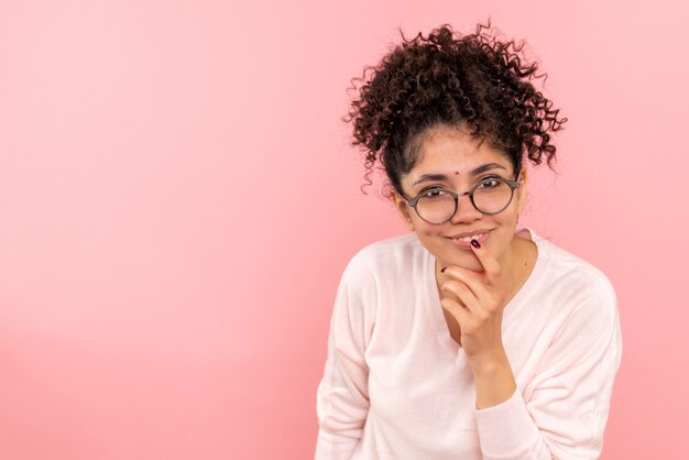 Vooraanzicht van jonge vrouw opgetogen op roze muur