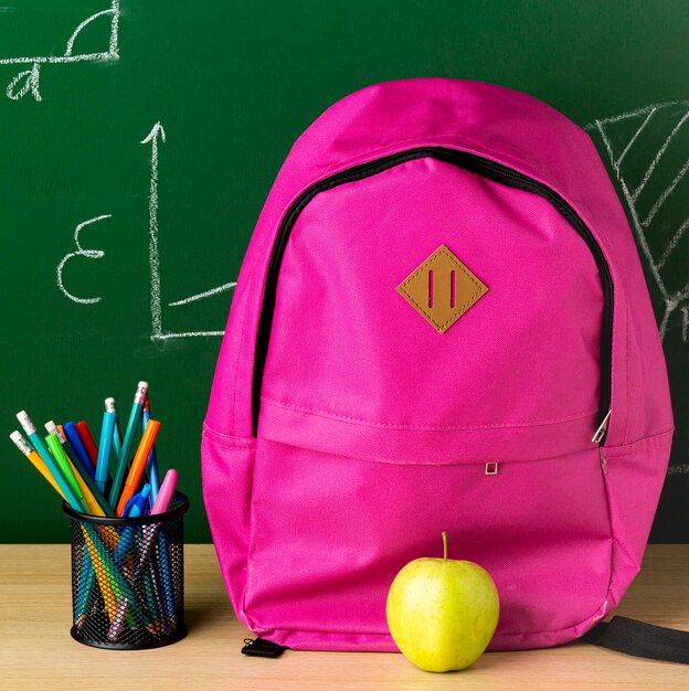 Vooraanzicht van rugzak voor terug naar school met appel en potloden