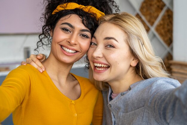 Vooraanzicht van twee gelukkige vrouwen die een selfie nemen