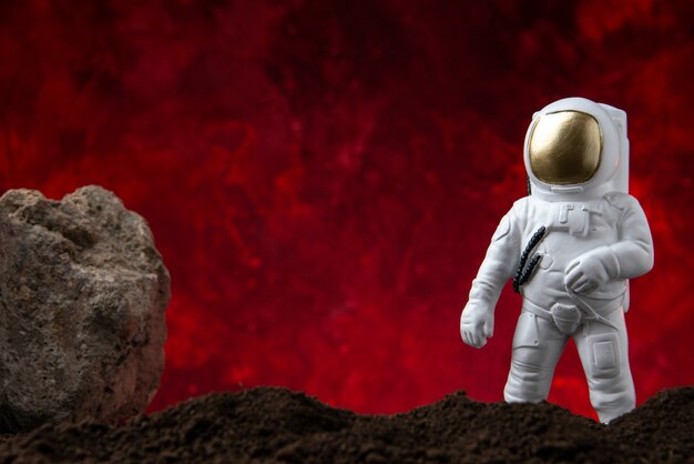 Vooraanzicht van witte astronaut op een maan op rode fantasie sci fi