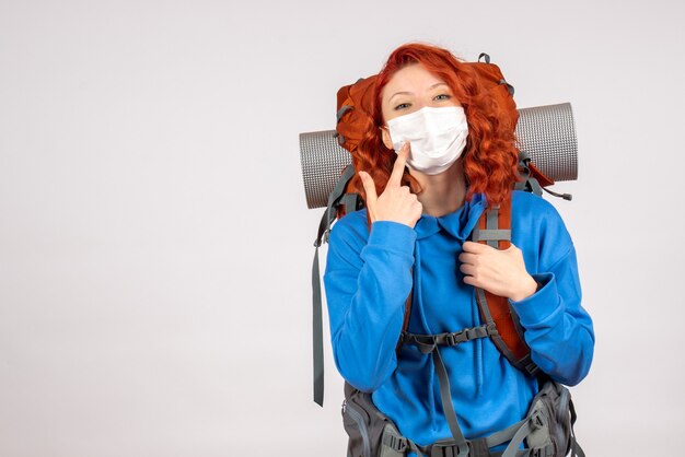 Vooraanzicht vrouwelijke toerist in masker met haar rugzak